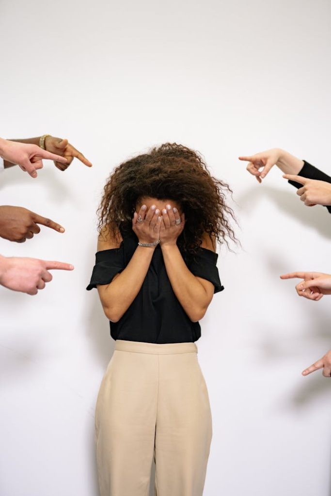 people-pointing-fingers-at-a-stressed-woman-7640730 People Pointing Fingers at a Stressed Woman